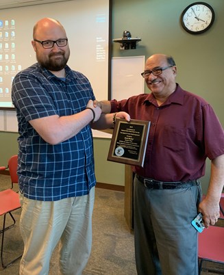 Strobel shaking hands with Sedgwick County Health Department representative John Lucero.