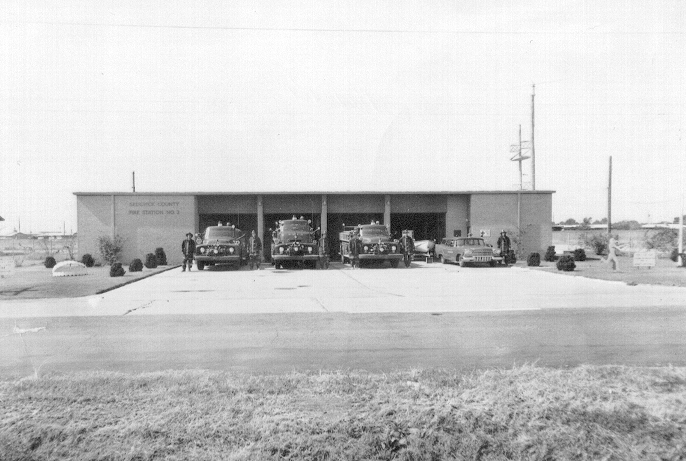 Fire trucks parked in front a fire station