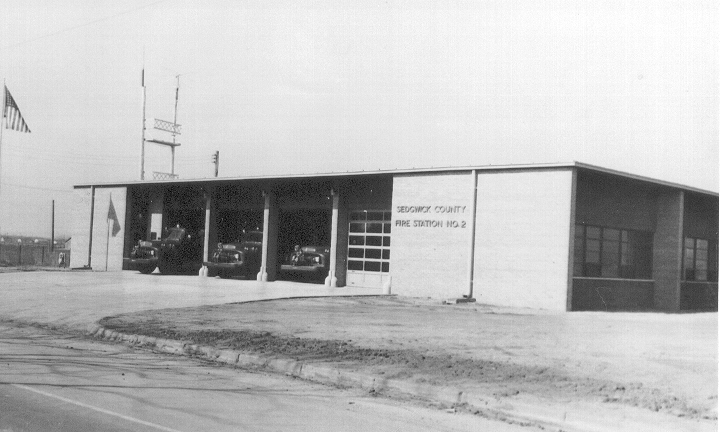old fire trucks parked inside a fire station