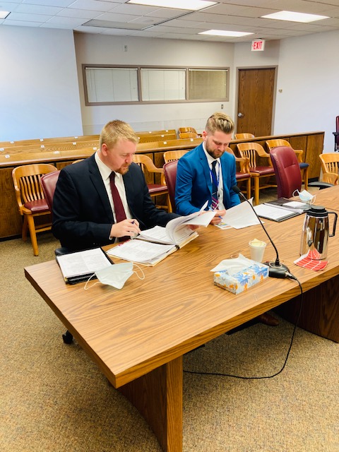 Prosecutor sitting at table