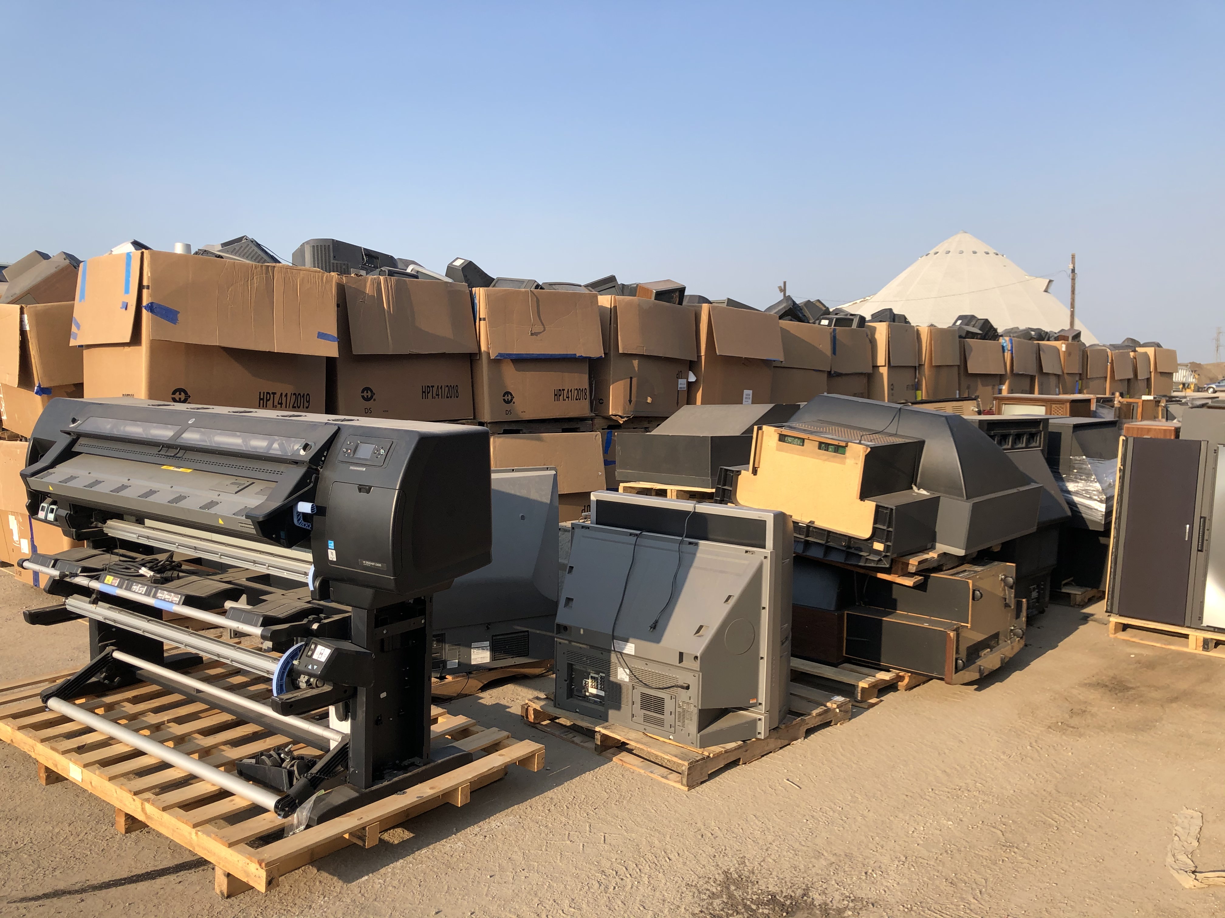 electronic waste in an industrial yard piled high
