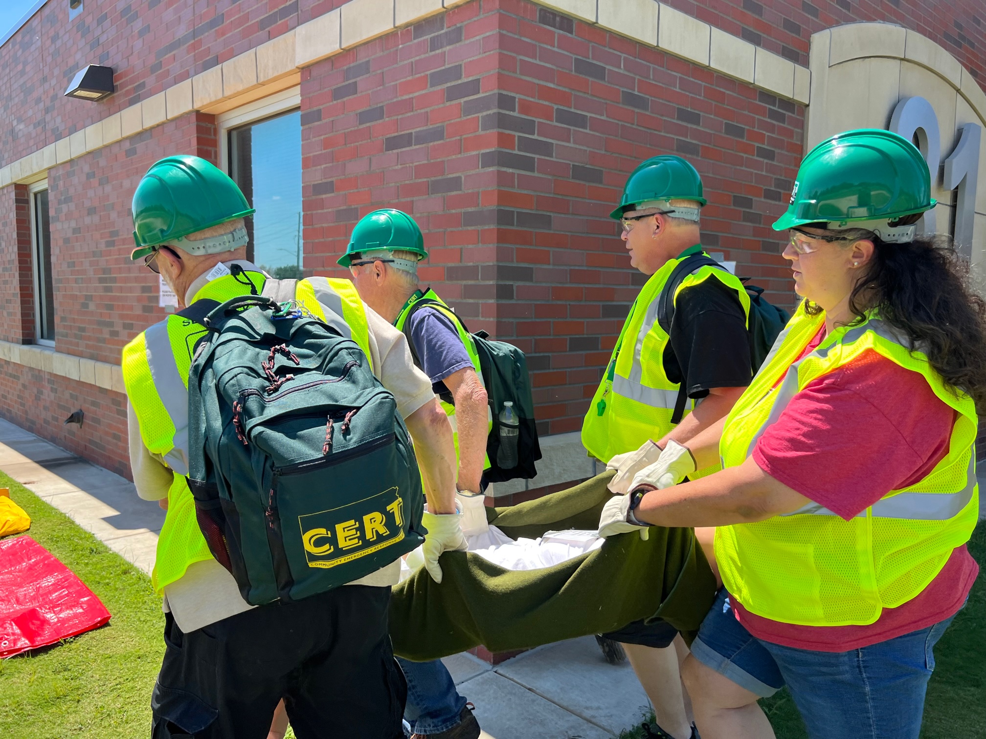 Participants moving a patient to the triage area during exercise