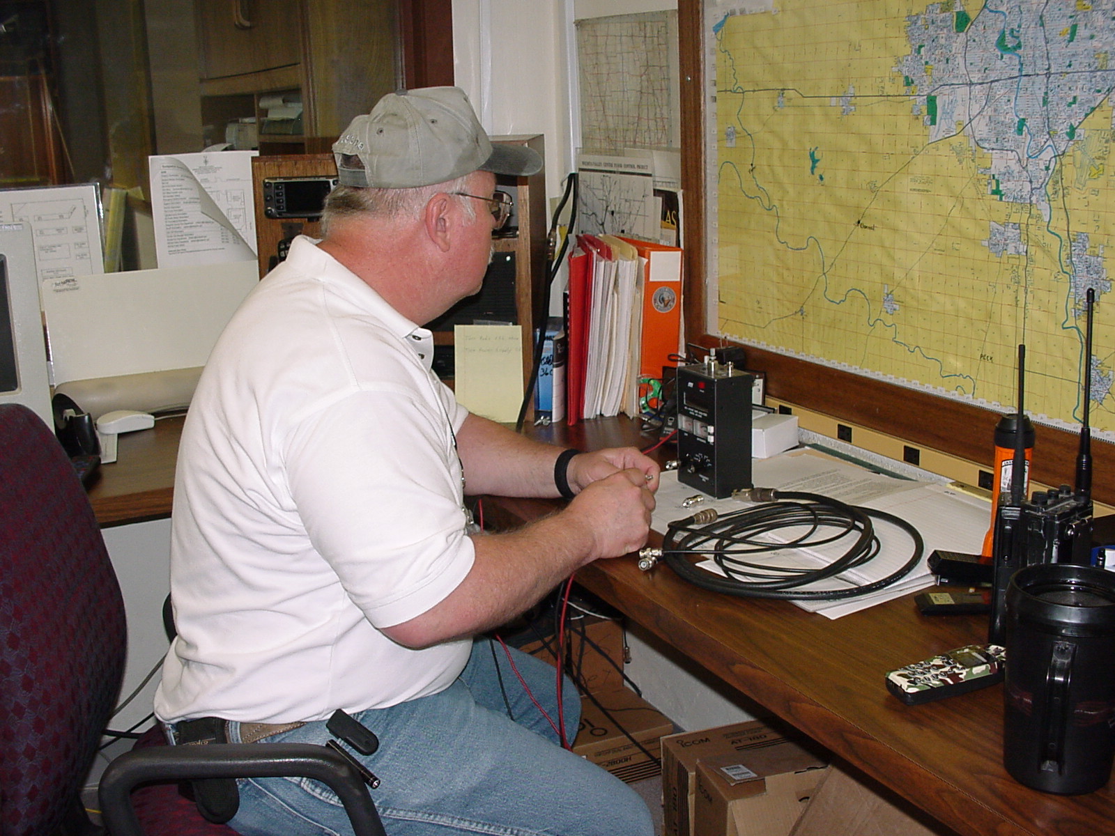 RACES Team Lead performing maintenance on a radio system