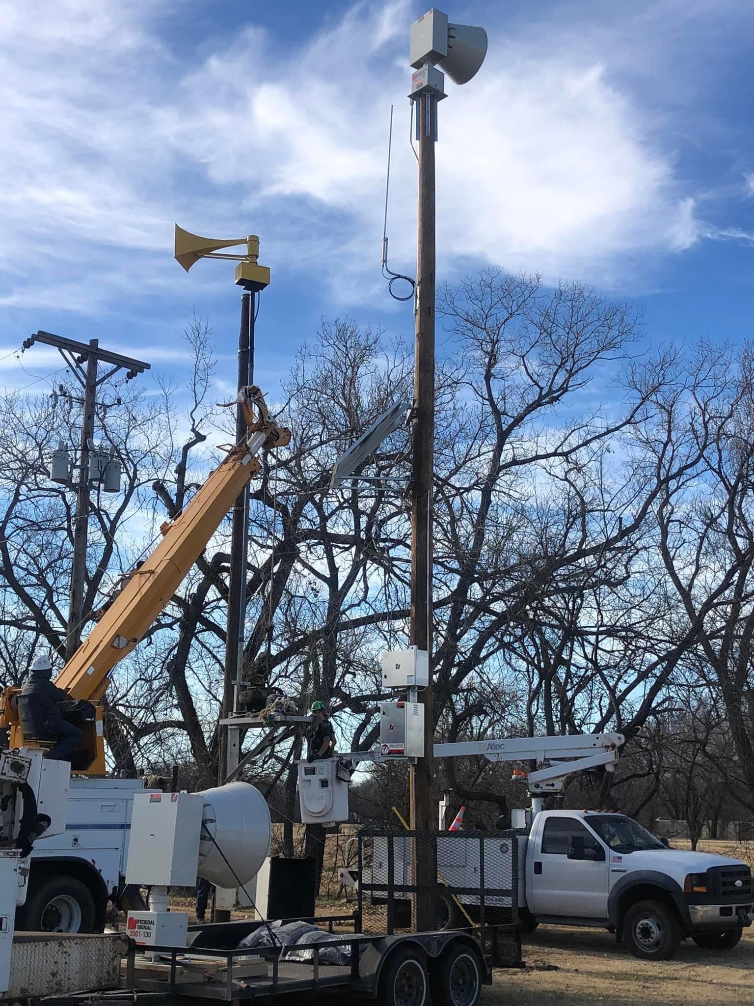This image shows a new siren being installed next to an old Thunderbolt  prior to the old siren being removed